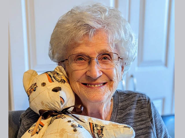 Audrey Chetney holding onto a teddy bear