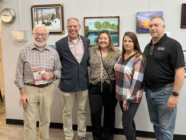 Barclay (2nd from left), Taylor Davis of the Chamber, and representatives from the CNY Arts Center pose in front of entries at a previous year's exhibit