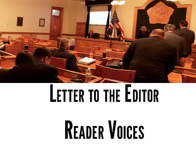A mostly empty legislature chamber with text underneath that says: Letter to the Editor Reader Voices.