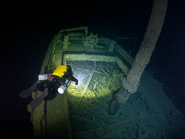 A diver explores the stern of Queen of the Lakes, which remains upright and relatively intact after sinking with a cargo of coal in 1906.
