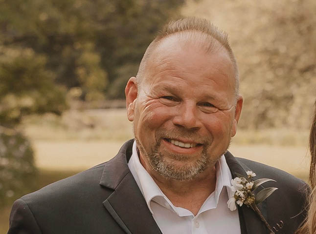 Beshures, an older balding white man in a suit
