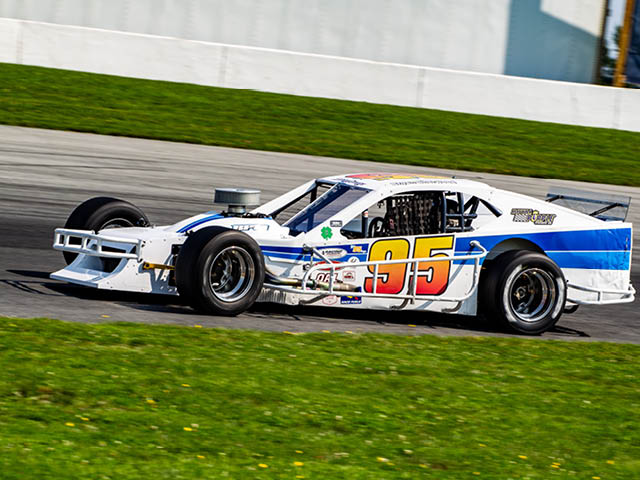 White race car with the number 95 on the side on the Evans Mills Raceway track