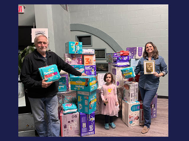 Fulton Rotarians in front of a table full of diapers