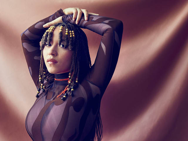 Kaia Kater with her arms over her head