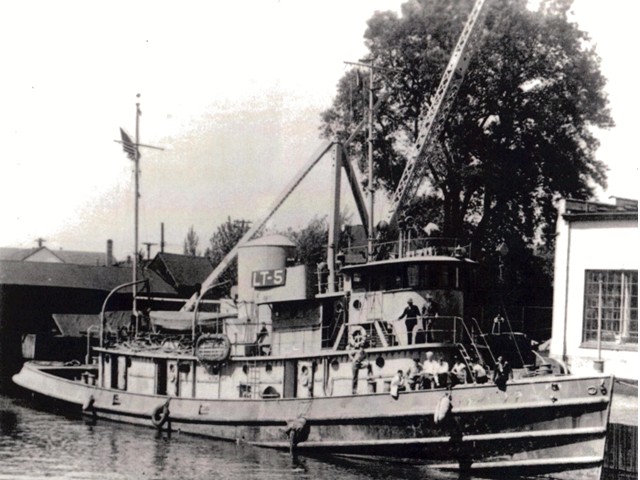 black and white photo of tug in harbor circa 1946
