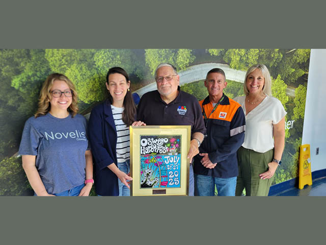 Harborfest Executive Director Dan Harrington, center, presents the festival's annual poster to Novelis leaders, from left, Jessica Westberry, Kristen Nelson, Dave Buske and Susan Cole.