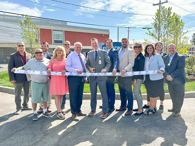 A group of officials about to cut a ribbon at Oswego Health's Fulton Medical Campus