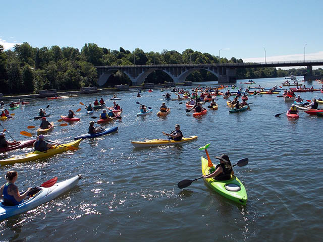 Kayakers on the Oswego River on a clear sunny day