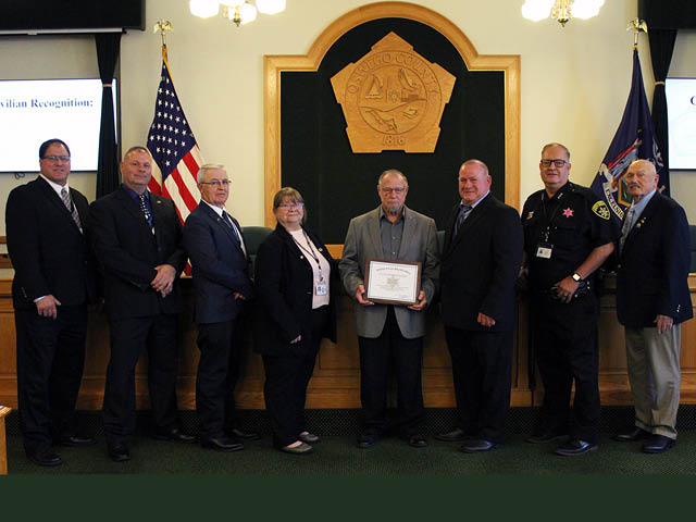 A line of people in the chambers of the county legislature