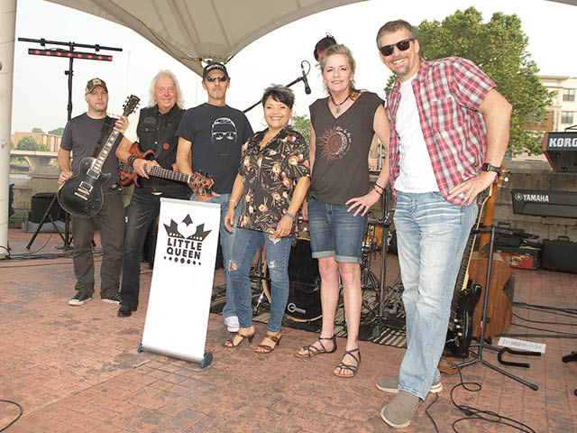 Band members of Little Queen posing on Veteran's Stage.