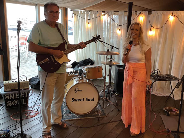 Sweet Soul Project band members holding a guitar and microphone