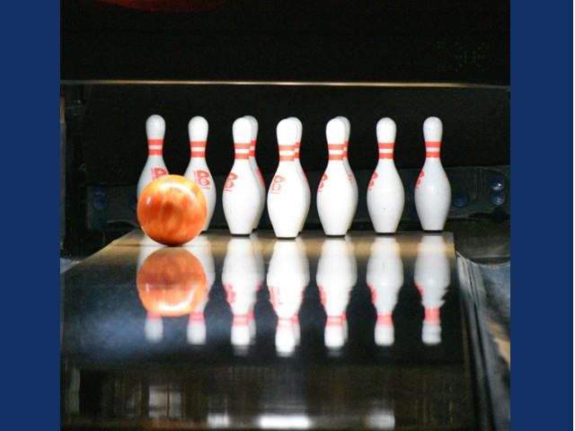 All pins standing as an orange ball roll toward them