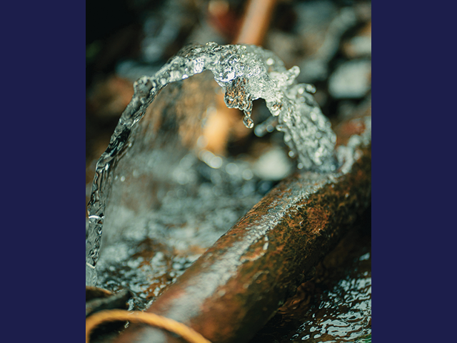 Photo of a small burst water pipe