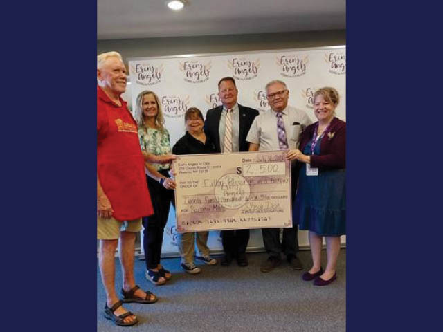 Group photo with a presentation check for Fulton Blessings in a Backpack