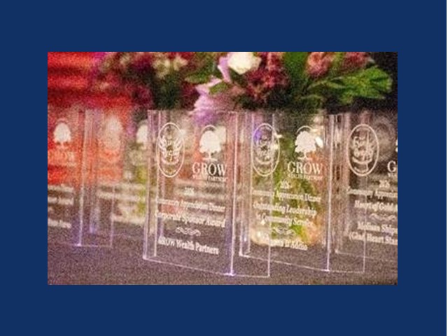 clear plaque awards standing on a table