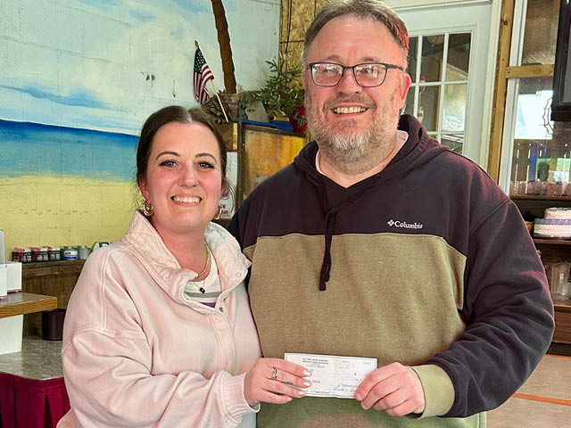  Fulton Lions President Melissa Champion, above, presents the donation to David Guyer, club past president and Memorial Day Salute committee member. 