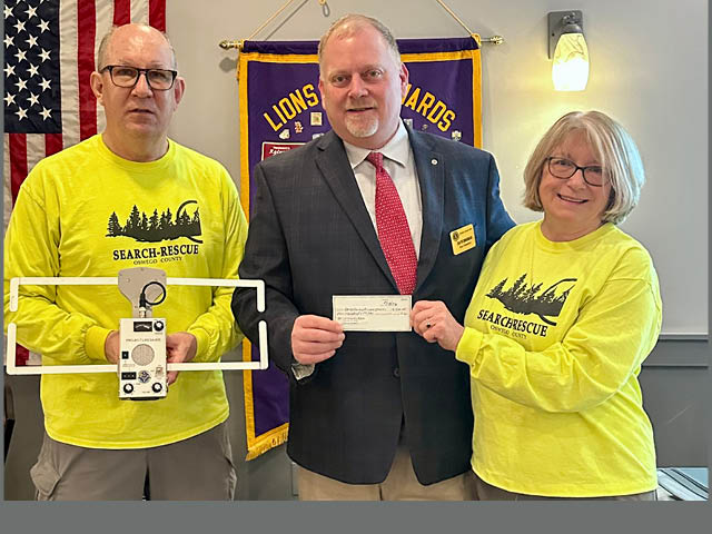 Photo of David Dingman, center, presenting a $500 donation to the Oswego County Pioneer Search &amp; Rescue Team, (OCPSRT), featured program at the club’s March meeting.  