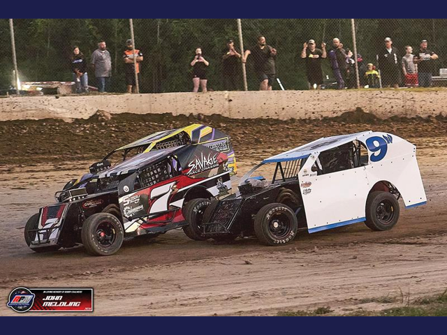 Two race cars at the Fulton Speedway on the dirt track