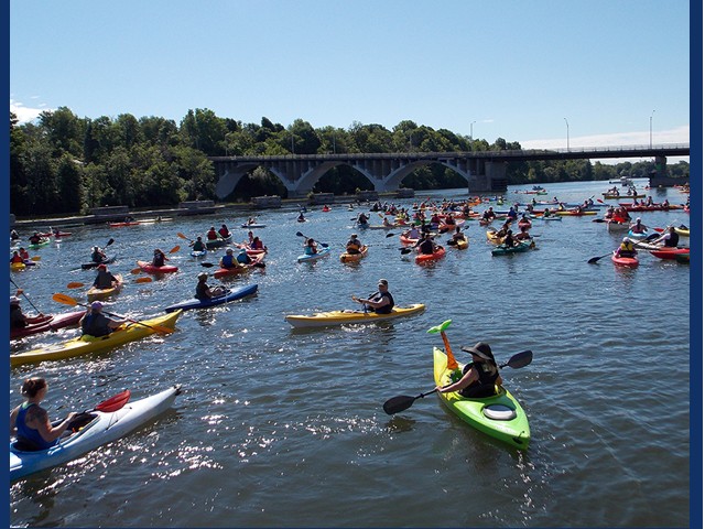 Kayaks in river with bridge in background