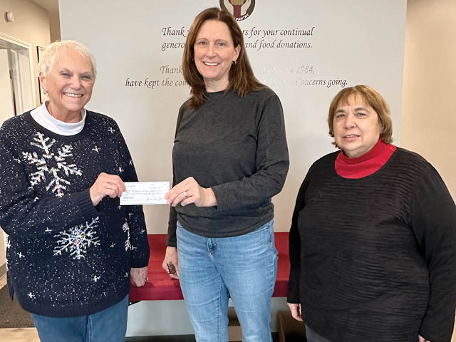 Presenting the check, Lee Audlin: P.E.O. Christmas party chair, Joanne Johnson: Human Concerns Board chair, Cecily Morrison: P.E.O. Scholarship chair. 