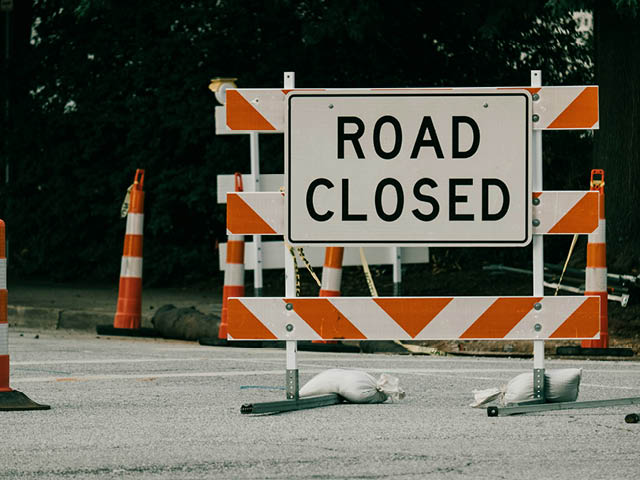 Photo of a road with a Road Closed sign