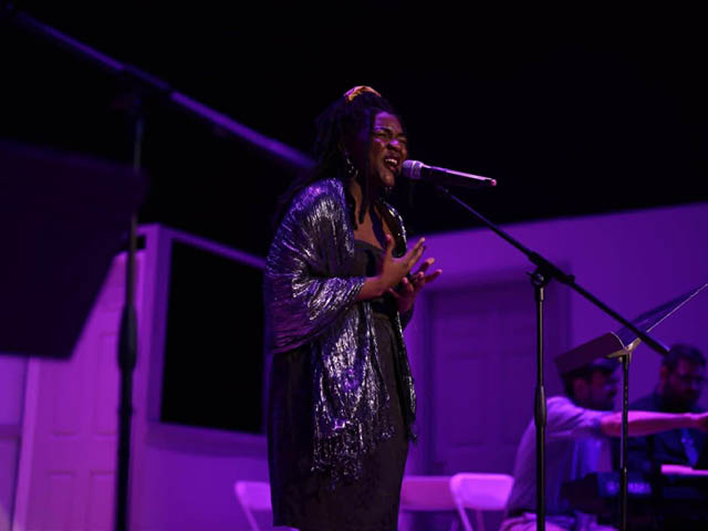 Shy Sims singing on-stage