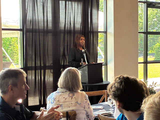 State Attorney General Letitia James speaks to a crowded room