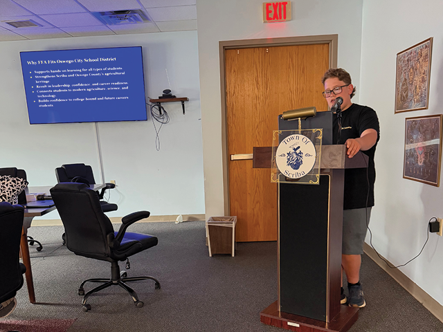 Photo: A teen boy named Bruce Pecorella at the podium in the Scriba Municipal Building